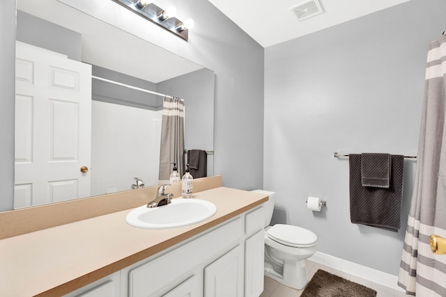 bathroom with tile patterned flooring, vanity, toilet, and walk in shower