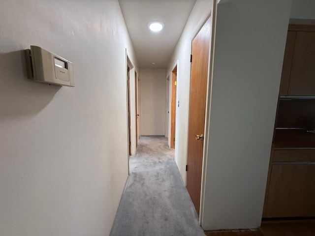 hallway featuring light carpet