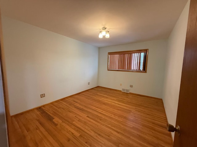 spare room with light hardwood / wood-style floors