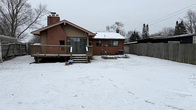 snow covered property featuring a wooden deck