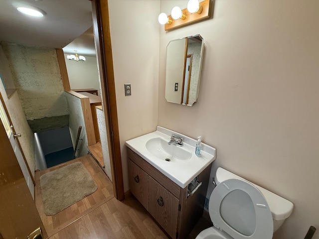 bathroom featuring vanity, hardwood / wood-style floors, and toilet