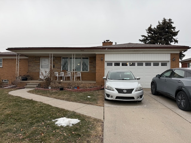 single story home featuring a garage, covered porch, and a front yard