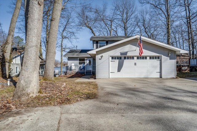 traditional-style house featuring an attached garage and concrete driveway