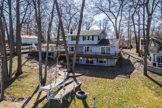 rear view of house with a deck and a chimney