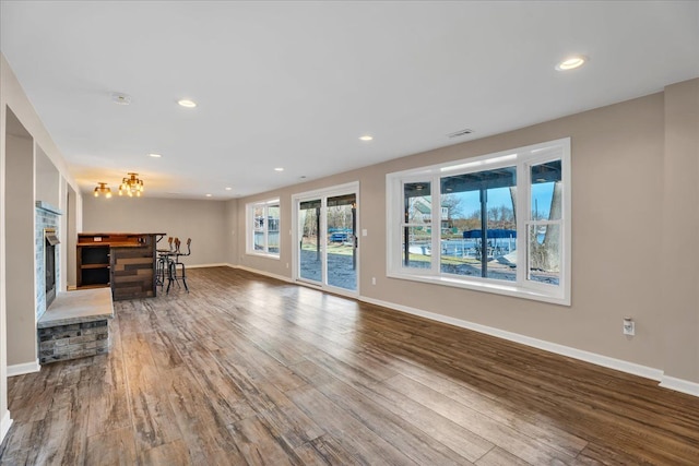 living area with recessed lighting, baseboards, and wood finished floors