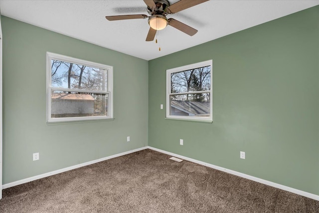 spare room with baseboards, a ceiling fan, and carpet flooring