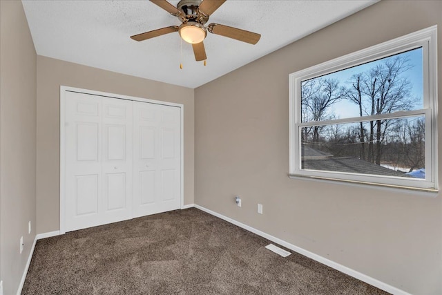 unfurnished bedroom featuring a closet, baseboards, and carpet floors