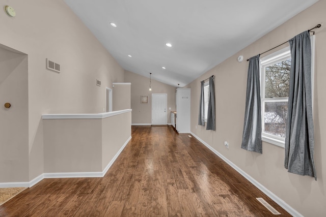 hall featuring dark wood-type flooring and lofted ceiling