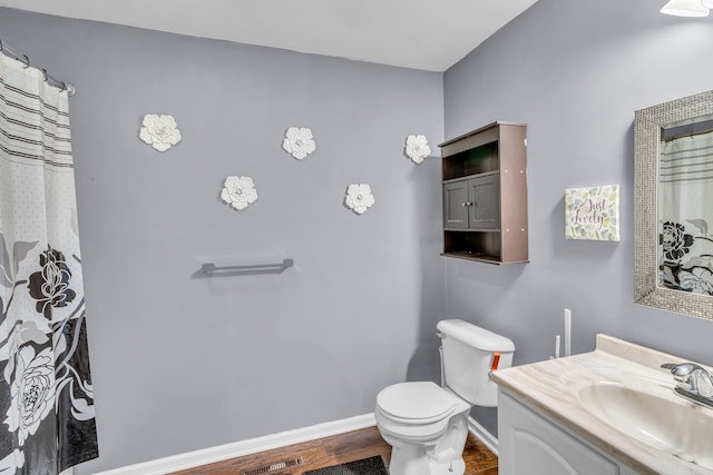 bathroom with vanity, hardwood / wood-style floors, and toilet