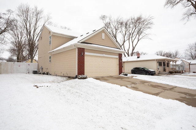 view of snowy exterior with a garage