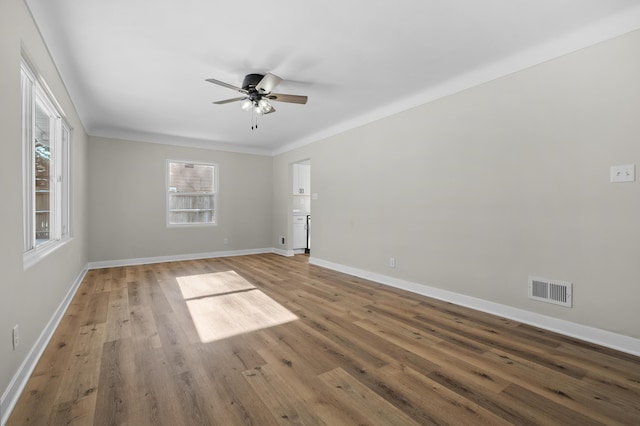 spare room featuring wood-type flooring and ceiling fan