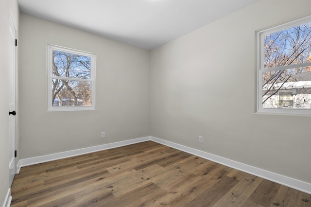 unfurnished room with dark wood-type flooring