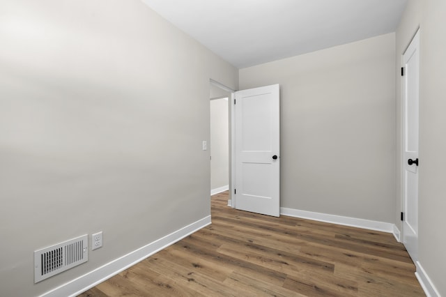 unfurnished bedroom with hardwood / wood-style floors