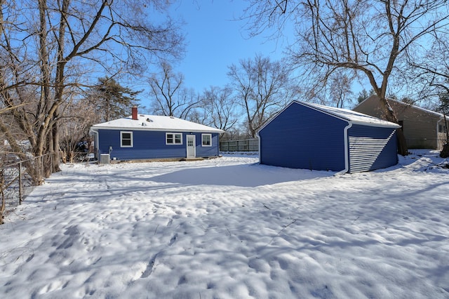 view of snow covered back of property