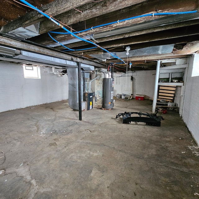 basement featuring water heater and heating unit