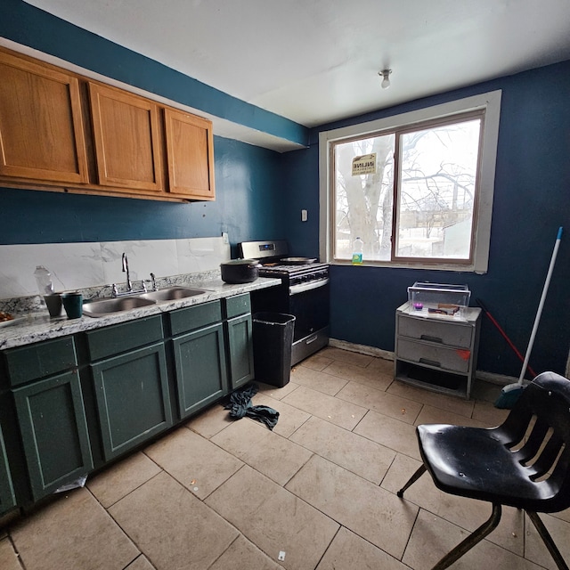 kitchen featuring sink, electric range, light stone countertops, and light tile patterned flooring