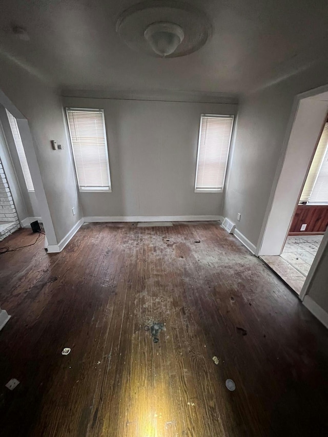 unfurnished room with hardwood / wood-style flooring