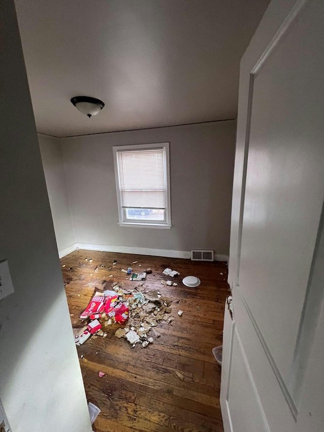 unfurnished room featuring dark hardwood / wood-style flooring