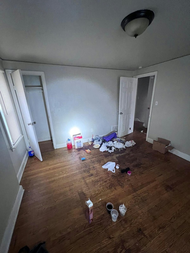 unfurnished bedroom with dark wood-type flooring