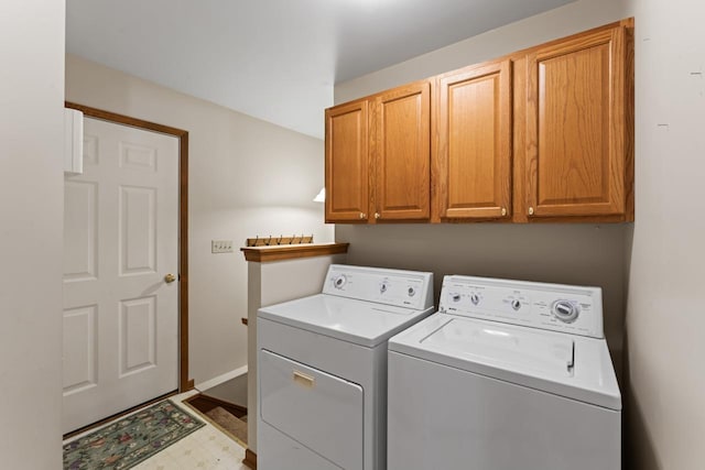 laundry area featuring cabinets and washing machine and dryer