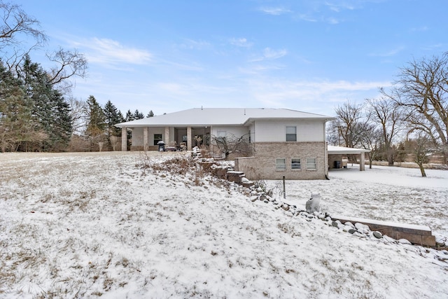 view of snow covered rear of property