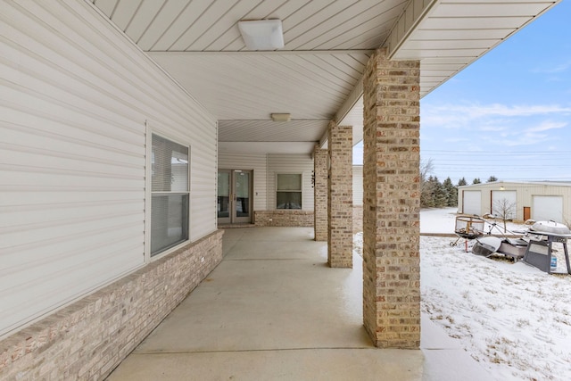 snow covered patio featuring grilling area