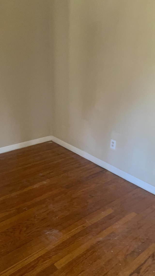 empty room featuring dark hardwood / wood-style floors