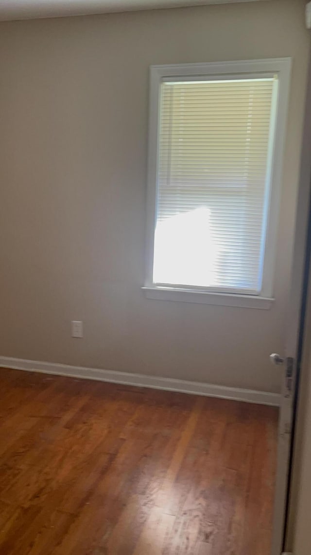 spare room with hardwood / wood-style flooring