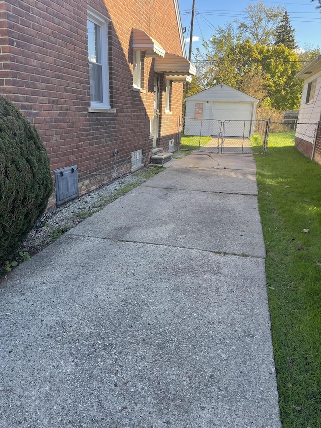 view of property exterior with a garage, an outbuilding, and a lawn