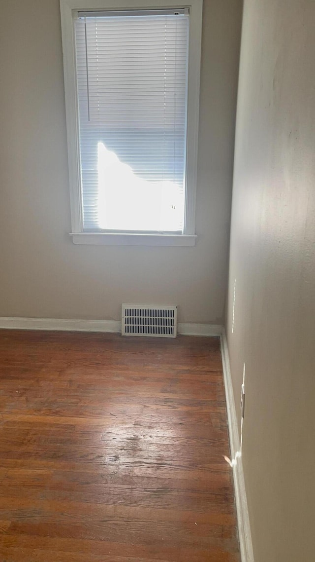 spare room with dark wood-type flooring