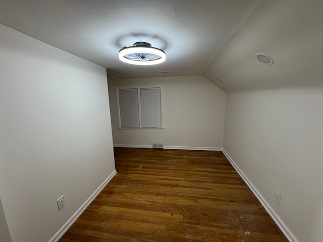 bonus room featuring dark hardwood / wood-style floors and vaulted ceiling