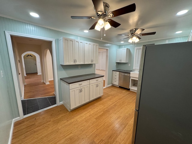 kitchen featuring stainless steel appliances, ornamental molding, white cabinets, and light hardwood / wood-style floors