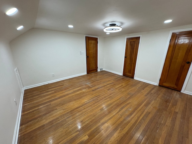 interior space featuring dark hardwood / wood-style floors and vaulted ceiling