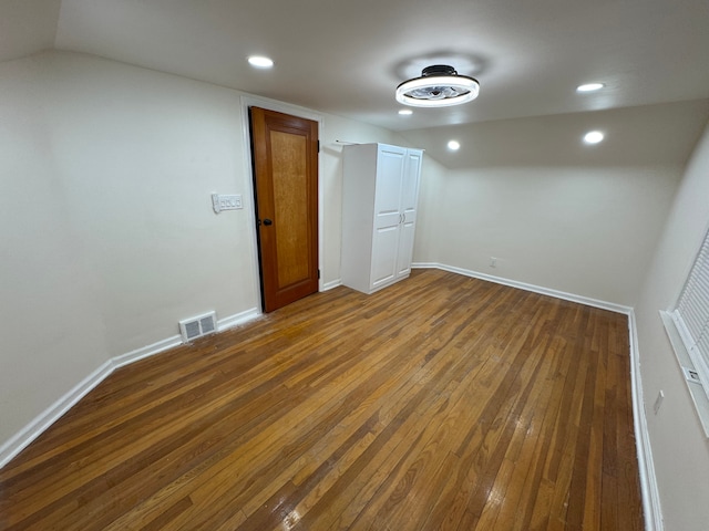 unfurnished room with dark hardwood / wood-style flooring