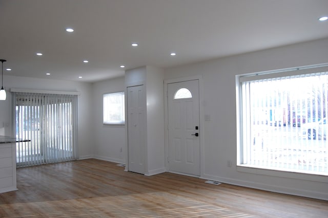 foyer entrance with light hardwood / wood-style flooring