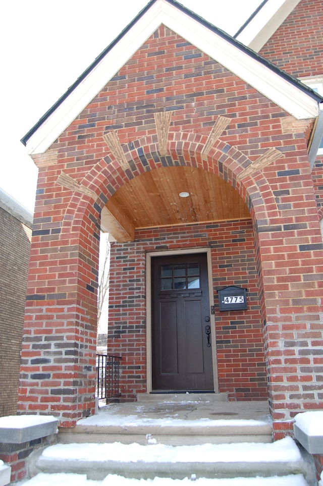 view of snow covered property entrance