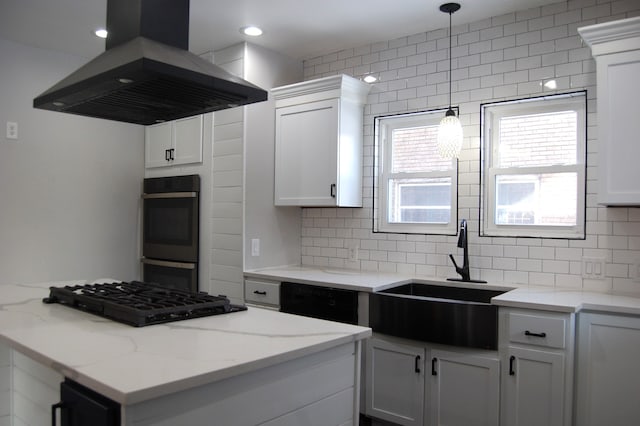 kitchen featuring sink, light stone counters, island range hood, black appliances, and white cabinets