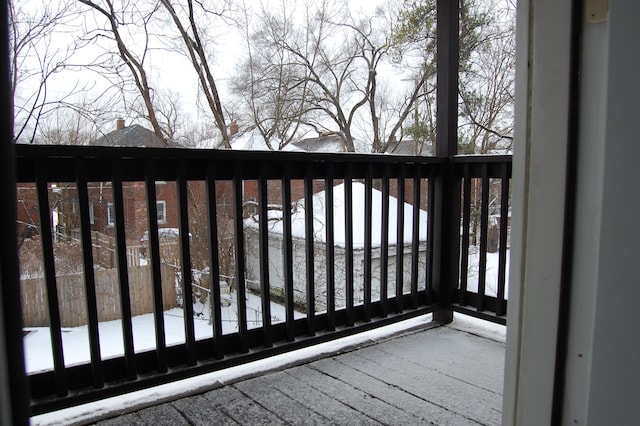 view of snow covered back of property