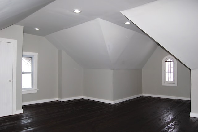 bonus room featuring dark hardwood / wood-style flooring, plenty of natural light, and vaulted ceiling