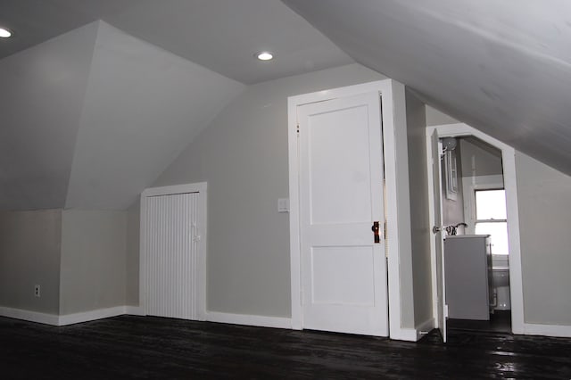 bonus room with lofted ceiling and dark wood-type flooring