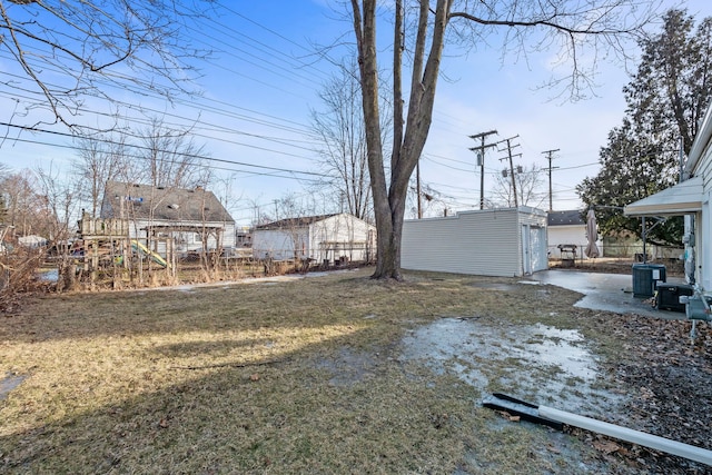 view of yard with an outdoor structure and central air condition unit