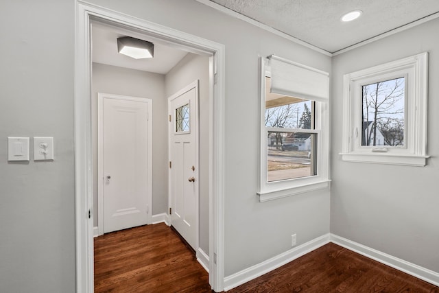 entrance foyer with dark hardwood / wood-style floors and a textured ceiling