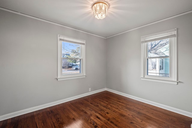 spare room with crown molding, wood-type flooring, and a healthy amount of sunlight