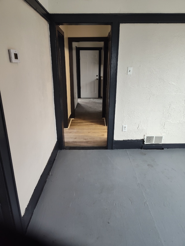 hallway with concrete floors