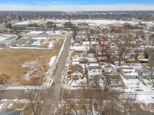 snowy aerial view with a residential view