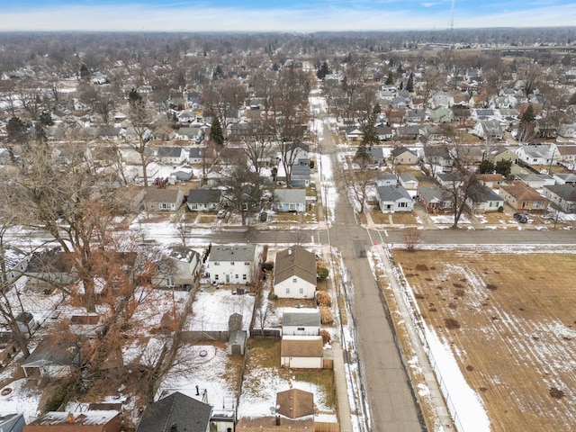 snowy aerial view with a residential view