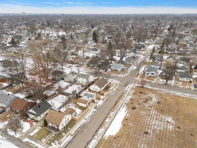 snowy aerial view with a residential view