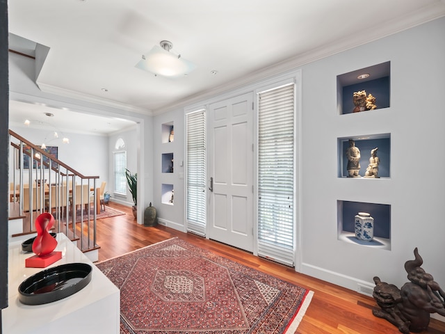 foyer featuring crown molding and wood-type flooring