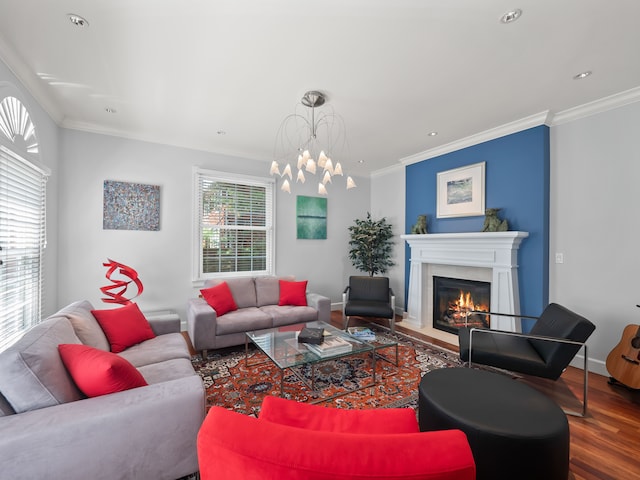 living room with a notable chandelier, hardwood / wood-style flooring, and ornamental molding