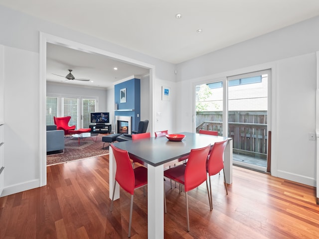 dining space featuring hardwood / wood-style flooring, ceiling fan, and crown molding
